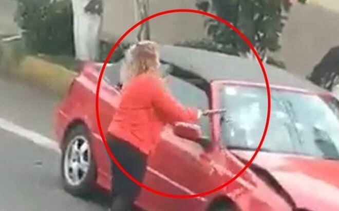 Mujer enfurece y destroza auto por conflicto vial